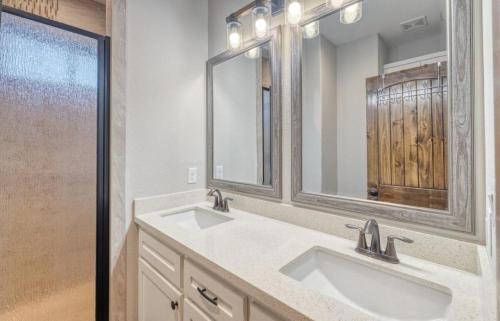 a bathroom with two sinks and a large mirror at Double Shotz in Concan