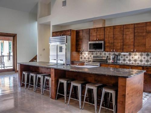 a kitchen with a large island with bar stools at Casa Estrella in Concan