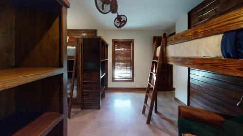 a room with several bunk beds and a staircase at Casa Estrella in Concan