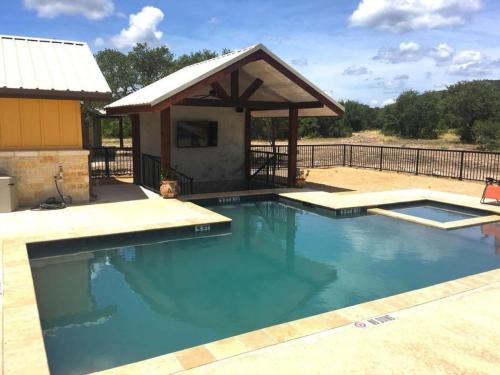 a large swimming pool with a gazebo at Casa Estrella in Concan