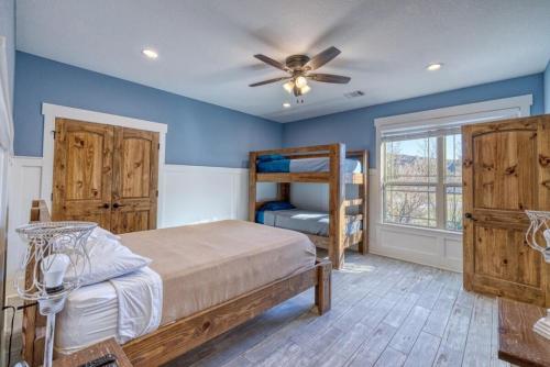 a bedroom with blue walls and a bed with a fan at Whiskey Rio in Concan