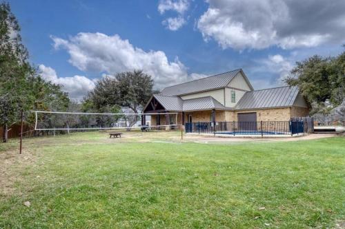 a house with a volleyball net in a field at Happy Hour in Concan