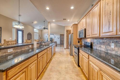 a large kitchen with wooden cabinets and counters at Happy Hour in Concan