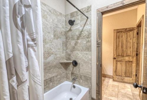 a bathroom with a shower and a white tub at Happy Hour in Concan