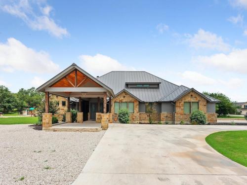 a house with a metal roof and a driveway at She's Like Texas in Concan