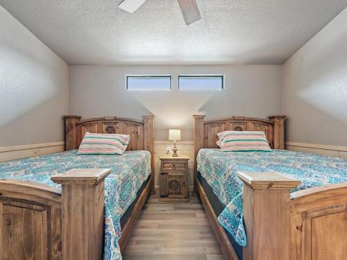 a bedroom with two beds and a night stand at She's Like Texas in Concan