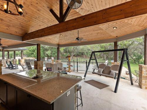 a pavilion with a table and chairs on a patio at She's Like Texas in Concan