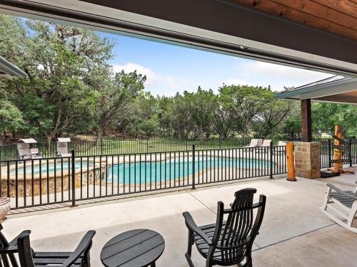 a patio with a view of a swimming pool at She's Like Texas in Concan