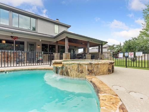 a house with a swimming pool in front of a house at She's Like Texas in Concan