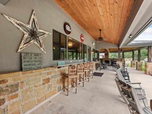 a restaurant with chairs and a star on the wall at She's Like Texas in Concan