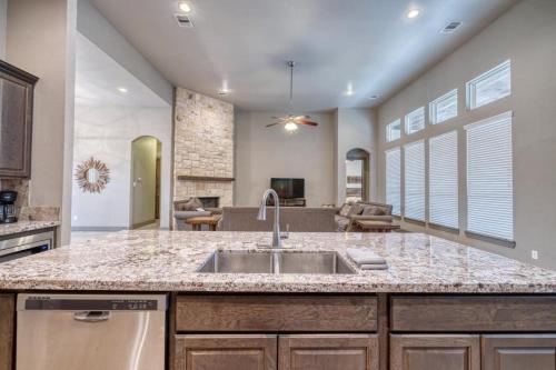 a kitchen with a sink and a living room at Driftwood in Concan