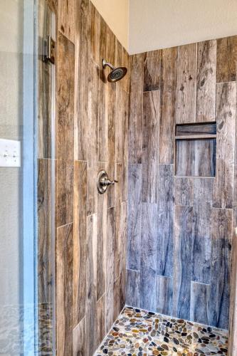 a bathroom with a shower with a wooden wall at Driftwood in Concan