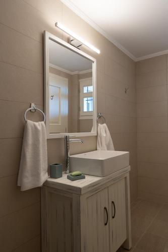 a bathroom with a white sink and a mirror at Ostria Studio, Kyparissia OldTown Home Collection in Kyparissia