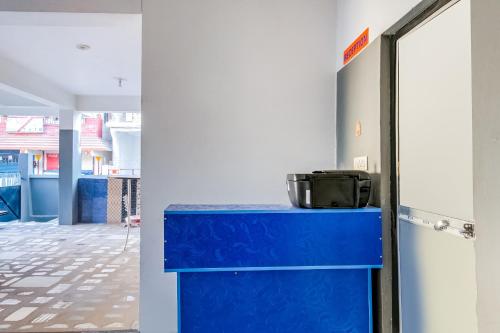 a blue counter in a room with a hallway at SPOT ON Hotel Rakesh International in Dānāpur
