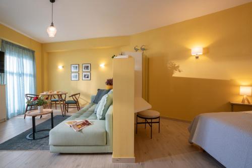 a hotel room with a bed and a couch and a table at Ostria Studio Kyparissia Old Town Collection in Kyparissia