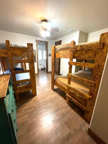 two bunk beds in a room with wooden floors at Ryder's Ridge in Concan