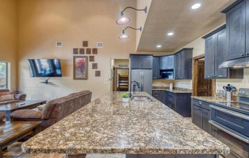 a large kitchen with a large island in the middle at Rolling Rock in Concan