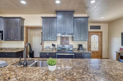 a kitchen with blue cabinets and a counter top at Rolling Rock in Concan