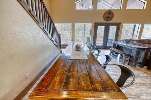 a long wooden table in a room with a piano at Rolling Rock in Concan