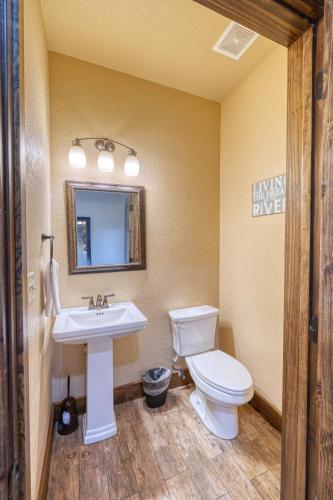 a bathroom with a toilet and a sink at Rolling Rock in Concan