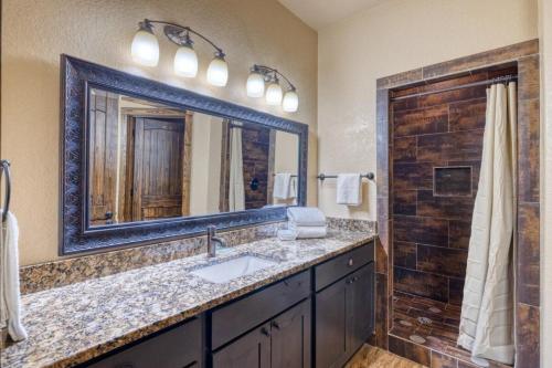 a bathroom with a sink and a mirror at Rolling Rock in Concan