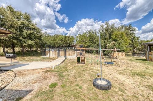 a park with a playground with a swing at Rolling Rock in Concan
