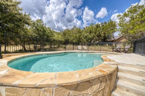 a swimming pool with a fence around it at Rolling Rock in Concan