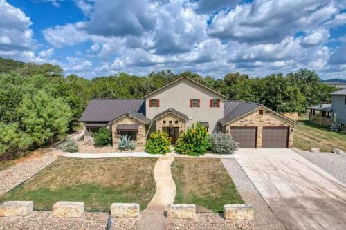 a house with a driveway and a garage at Rolling Rock in Concan