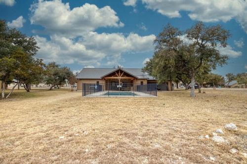 a home in a field with a house at Rockin' Rio in Concan