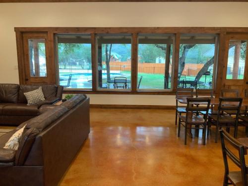 a living room with a couch and a table and chairs at Double L River House in Concan