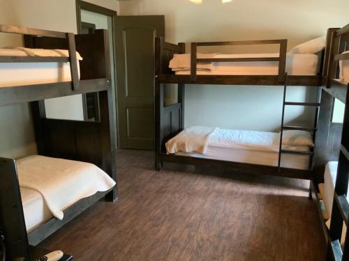 a room with three bunk beds in it at Big Cinchin' in Concan