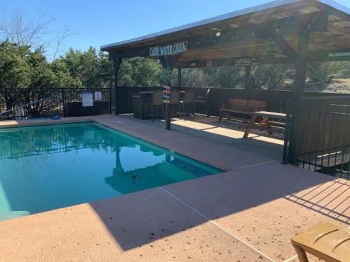 a swimming pool with a pavilion and a picnic table at Clear Water Casa in Concan