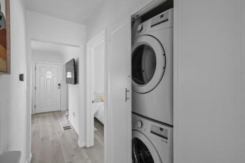 eine weiße Waschküche mit Waschmaschine und Trockner in der Unterkunft Urban Spanish Bungalow in San Diego
