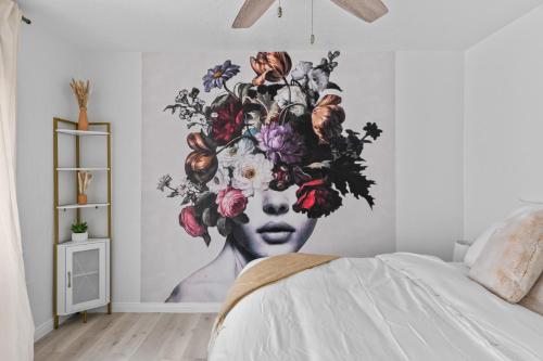 a mural of a woman with flowers on a wall at Urban Spanish Bungalow in San Diego