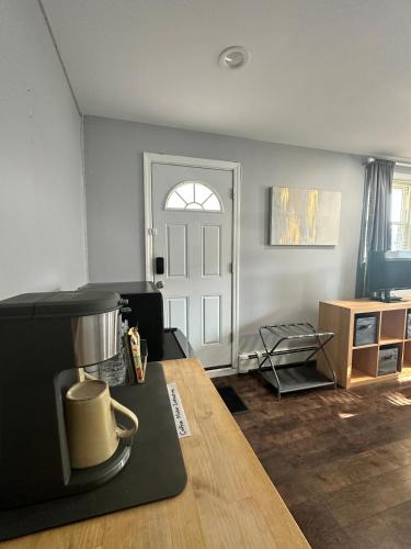 a living room with a table and a door at ZenOasis pvt BedBath Studio by NUMC in East Meadow