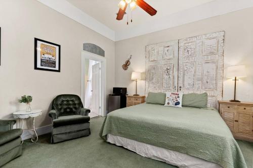 a bedroom with a bed and a chair at #12 The Gruene Room at Garrison in Gruene in New Braunfels