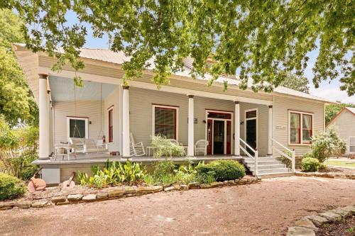 a white house with a porch and a driveway at #12 The Gruene Room at Garrison in Gruene in New Braunfels
