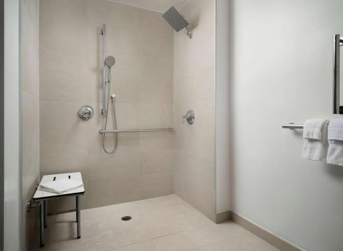 a bathroom with a shower and a sink at Sonesta White Plains Downtown in White Plains