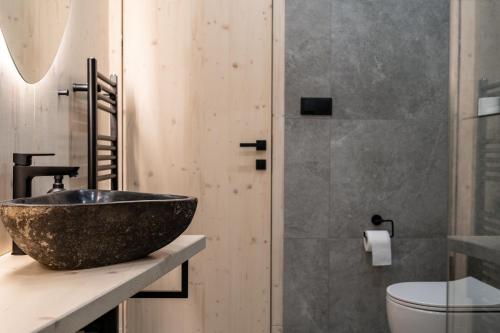 a bathroom with a bowl sink and a shower at Pine chalet in Smižany