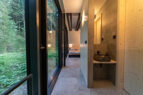 a house in the woods with a large window at Pine chalet in Smižany