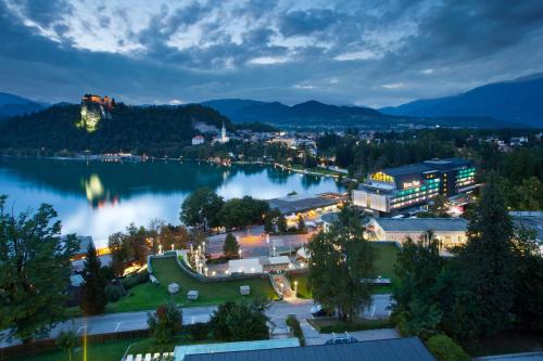 a view of a town and a lake at night at Hotel Park - Sava Hotels & Resorts in Bled