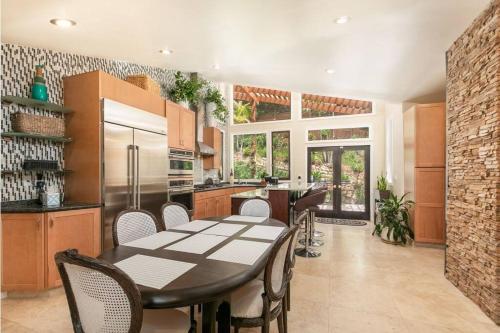 a kitchen with a table and chairs in a kitchen at Skyhill Oasis New Lux Designer Modern in Los Angeles