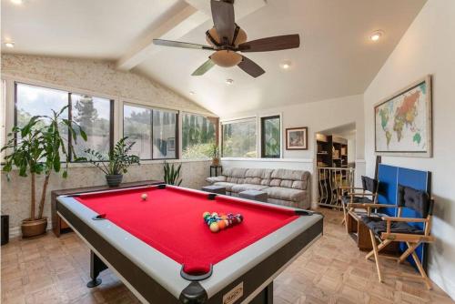 a pool table in a living room with a ceiling fan at Skyhill Oasis New Lux Designer Modern in Los Angeles