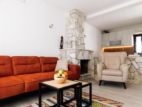 a living room with a couch and a fireplace at Cozy Karuč Home in Cetinje