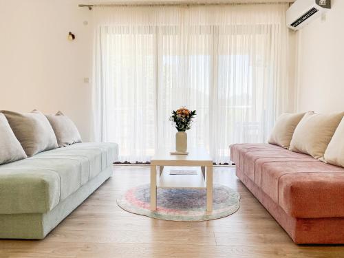 a living room with a couch and a table at Cozy Karuč Home in Cetinje