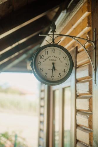 a clock hanging on the side of a wall at Kuća Luna in Gornji Milanovac