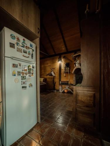 a kitchen with a white refrigerator in a room at Kuća Luna in Gornji Milanovac
