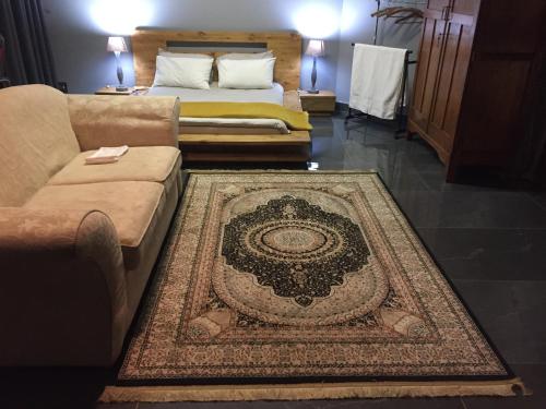 a living room with a couch and a rug at The Concept in Centurion