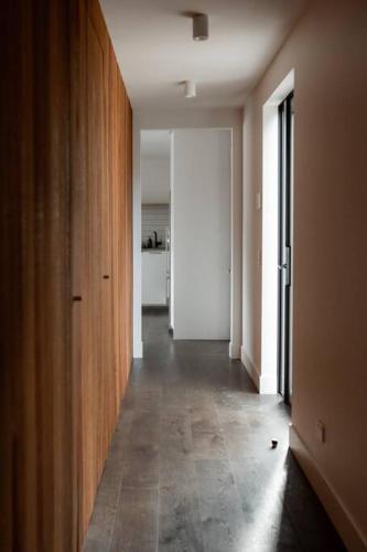 an empty hallway with a room with a door and a hallwayngthngthngthngth at The Pines Guesthouse - new re-list in Arrowtown