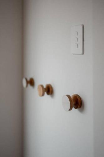 a white door with wooden knobs on it at The Pines Guesthouse - new re-list in Arrowtown